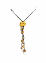 Yellow clay orange peel flower pendant necklace made with rolled wooden beads on an eco friendly black cord