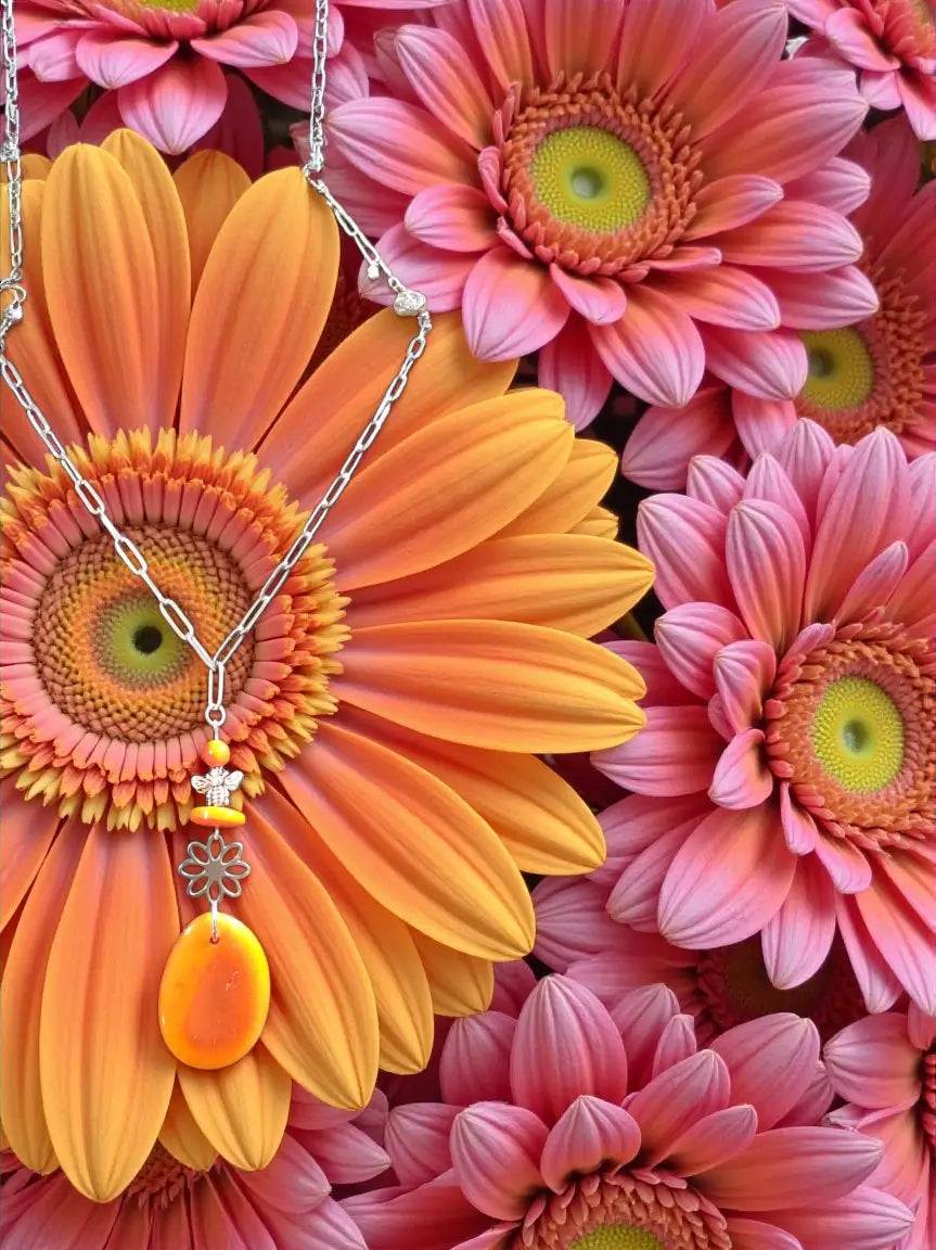 A delicate silver chain orange tagua necklace with yellow bee charm fair trade eco-friendly jewelry gift