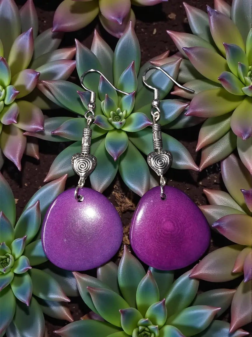 Plum purple teardrop tagua nut earrings with silver-toned swirly heart bead charms and hooks
