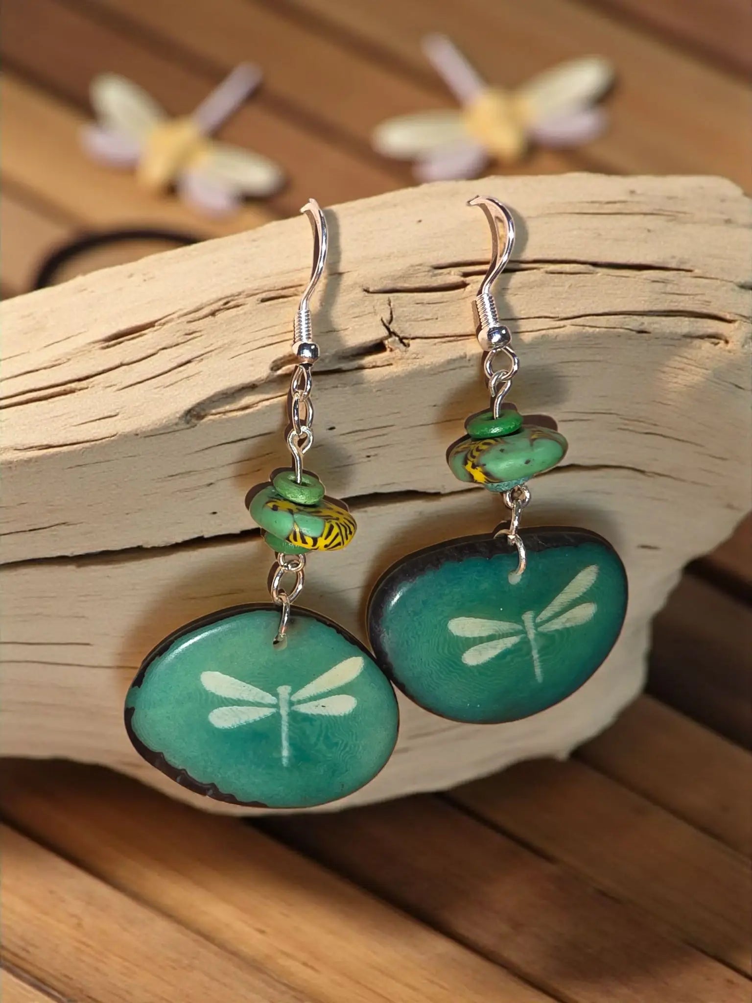 Teal dragonfly-themed pendant earrings with silver hooks and small green beads in turquoise dyed design