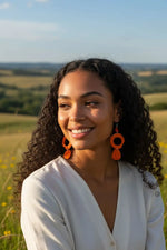 Pumpkin orange thick hoop ring tagua slice earrings featuring vibrant orange circular drop design