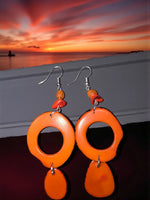 Vibrant pumpkin orange thick hoop ring tagua slice earrings with dangling teardrop beads and silver hooks