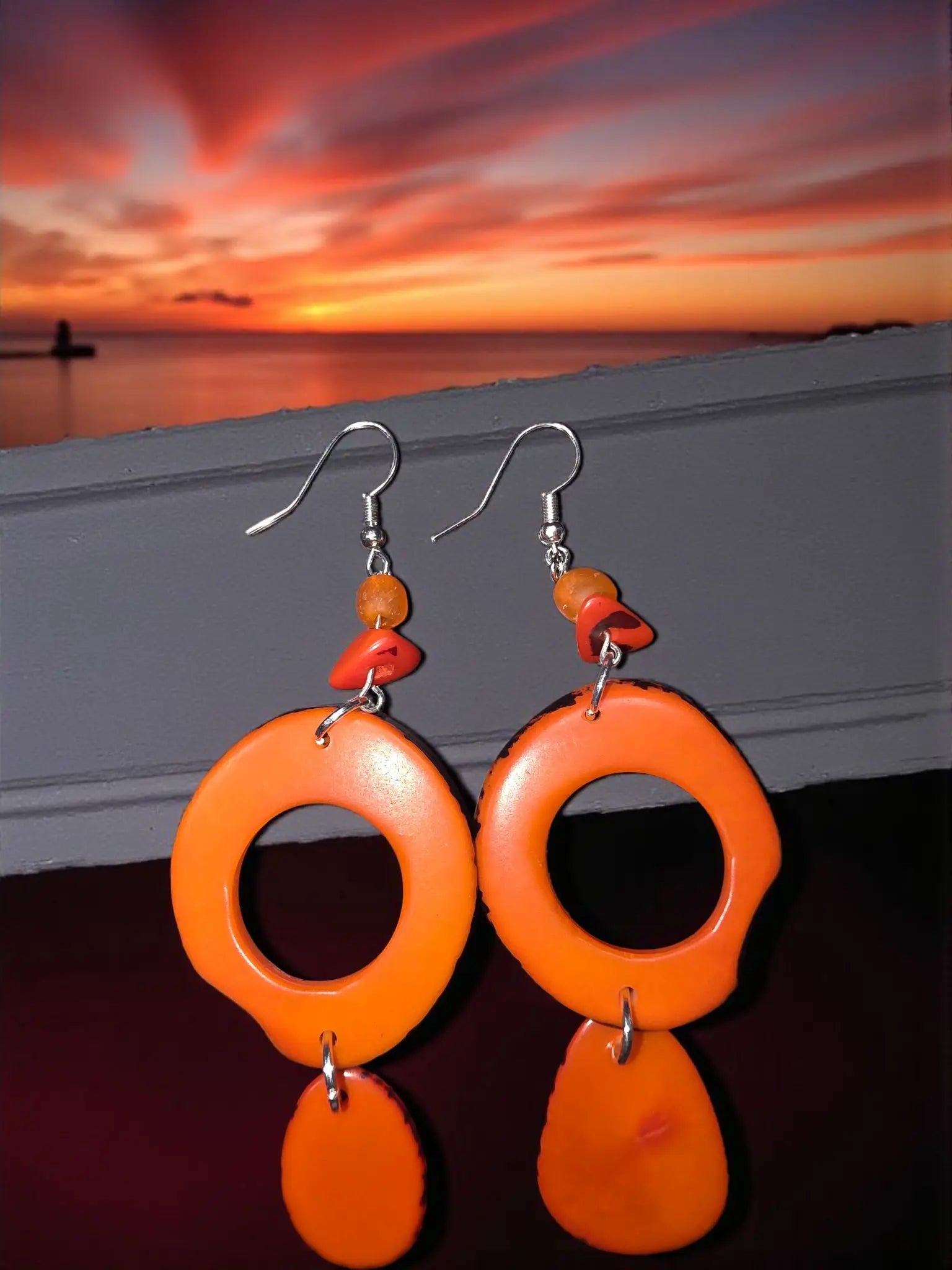 Vibrant pumpkin orange thick hoop ring tagua slice earrings with dangling teardrop beads and silver hooks
