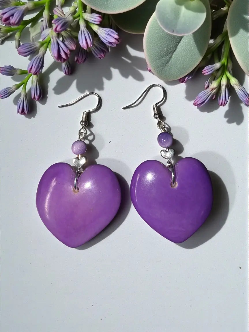 Purple carved heart lightweight solid tagua nut earrings with glossy finish silver hooks and small purple beads