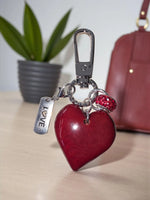 Red carved heart tagua handmade bag purse charm or keychain with silver love tag and sparkling red bead attached to clasp