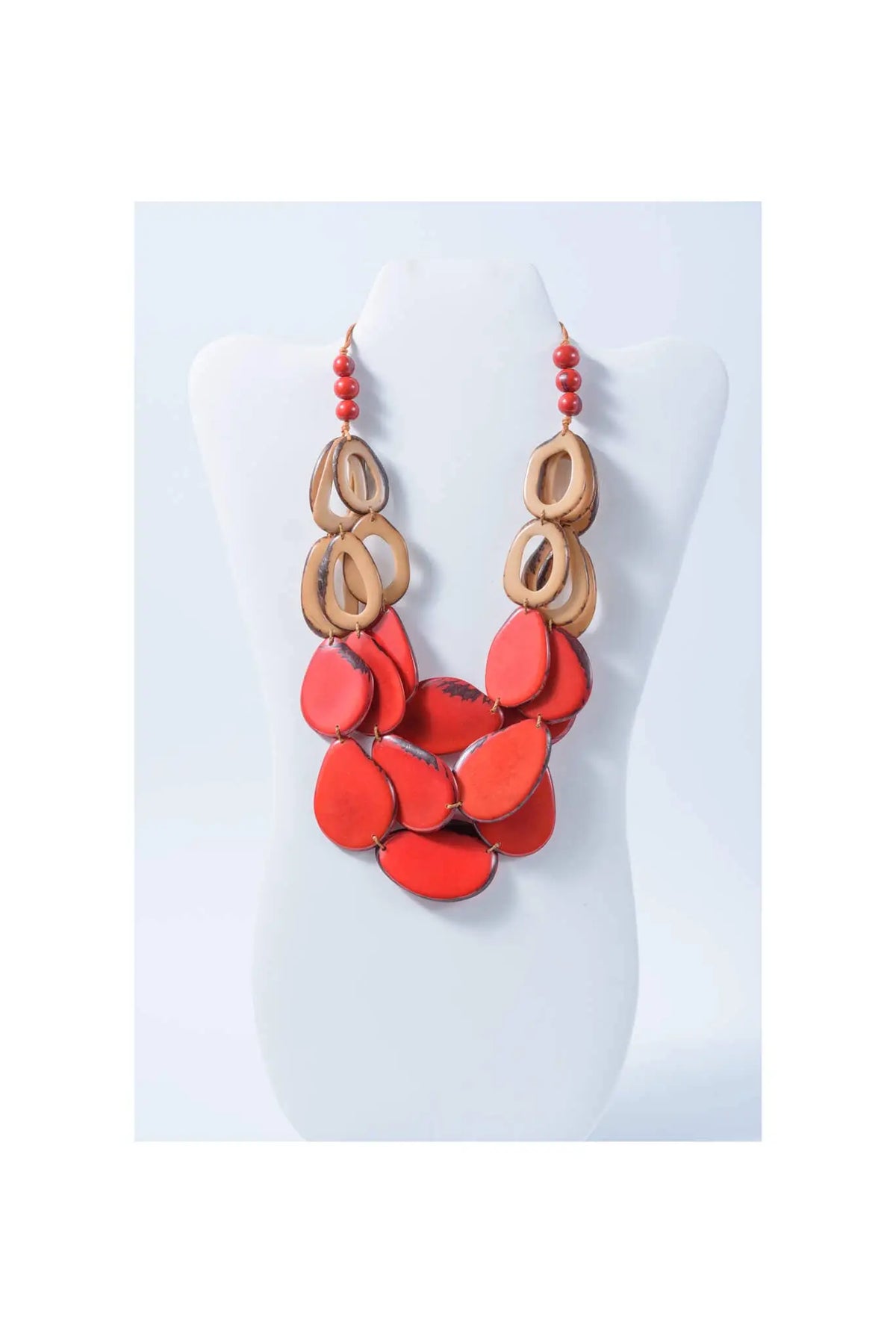 Remy vibrant tagua necklace with coral-red and natural wood tones featuring layered circular and teardrop beads