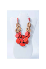 Remy vibrant tagua necklace with coral-red and natural wood tones featuring layered circular and teardrop beads