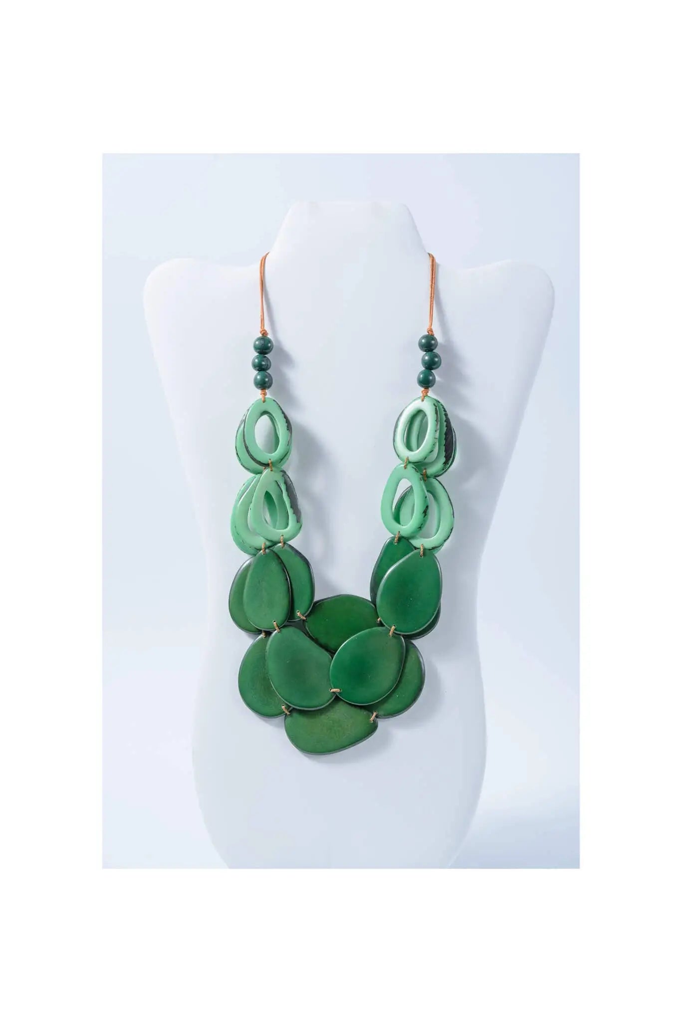 Remy vibrant tagua necklace with green layered oval and teardrop beads accented by dark green spheres and copper hooks
