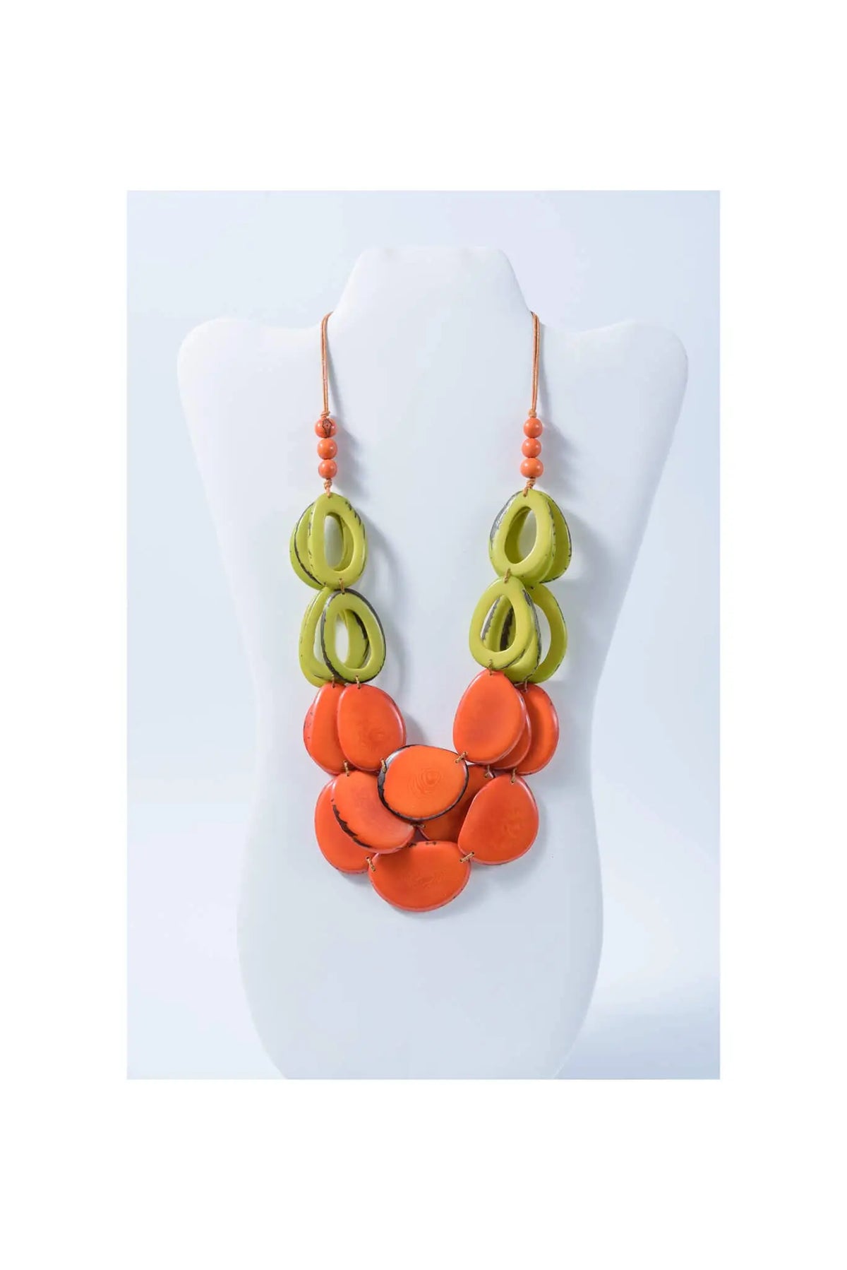 Remy vibrant tagua necklace with loop accents featuring layered orange and lime green circular flat disc beads