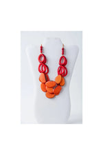 Vibrant red and orange layered remy tagua necklace with bold glossy resin beads and loop accents in olive green and beige