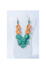 Remy vibrant tagua necklace with loop accents featuring a turquoise and orange layered resin bead design