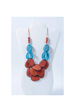 Remy vibrant tagua necklace with loop accents features turquoise and terracotta layers with glossy oval beads