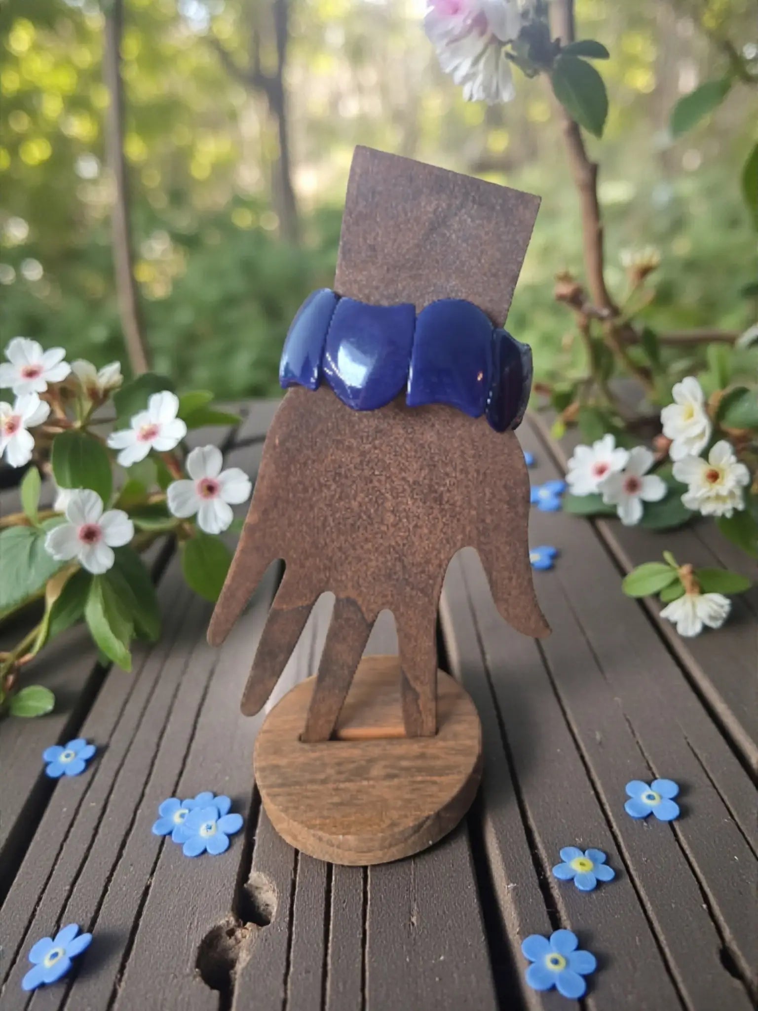 Rich navy blue carved vegan tagua nut vegetable ivory bracelet displayed on rustic wooden hand stand forest seed bracelets