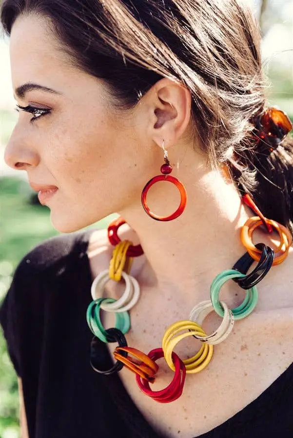 Vibrant ring of life earrings featuring multicolored interlocking plastic ring links in red orange yellow green black and white
