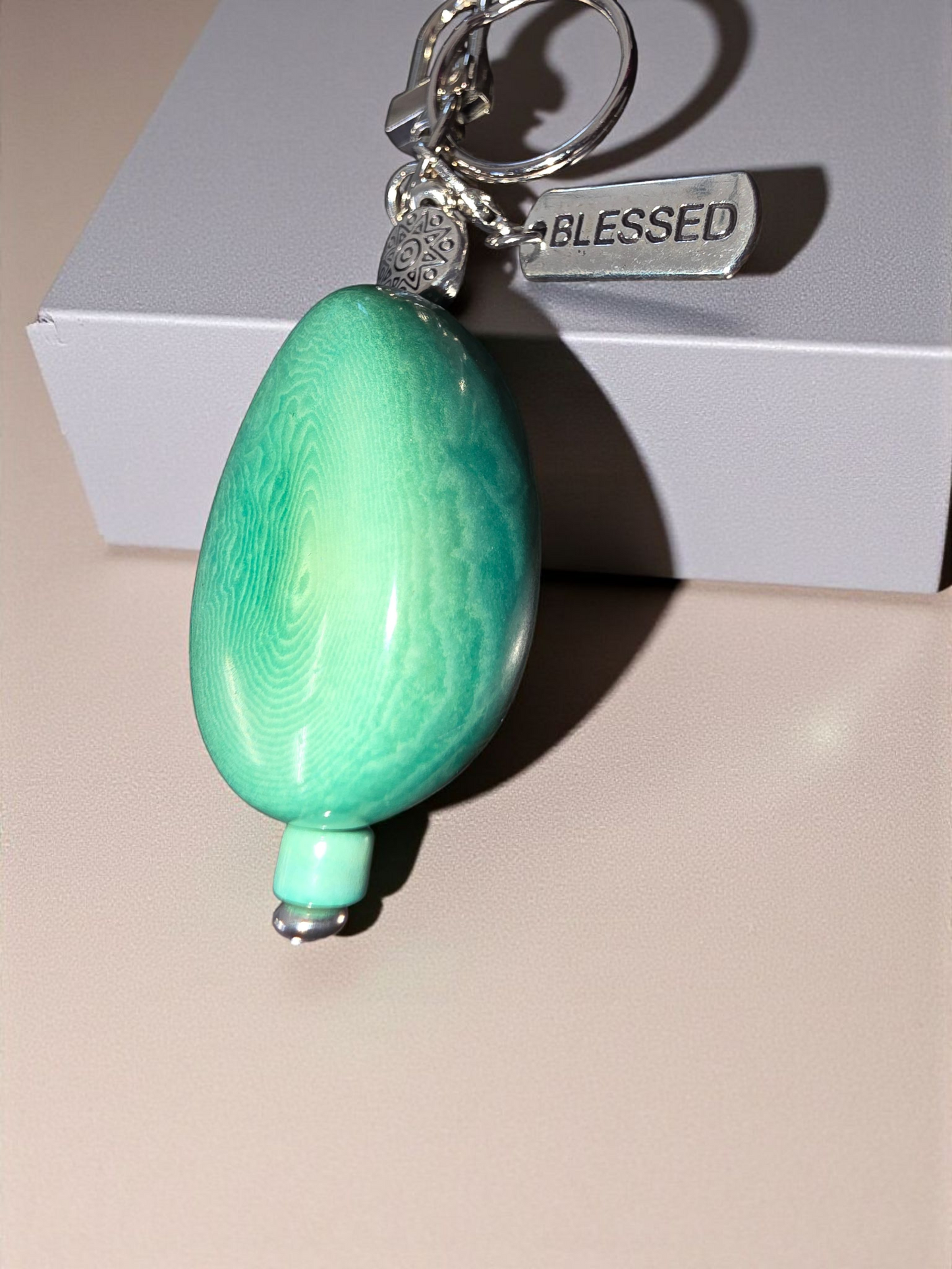 BLESSED : Large Carved Turquoise Dyed Tagua Piece Bag Charm or Keychain with Tibetan Amulet Metal Bead