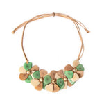 Rosalia necklace pastel multi featuring layered handcrafted flower clusters in green and beige on a tan leather cord