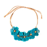 Rosalia necklace featuring a turquoise flower-shaped pendant on a tan leather cord in pastel multi colors