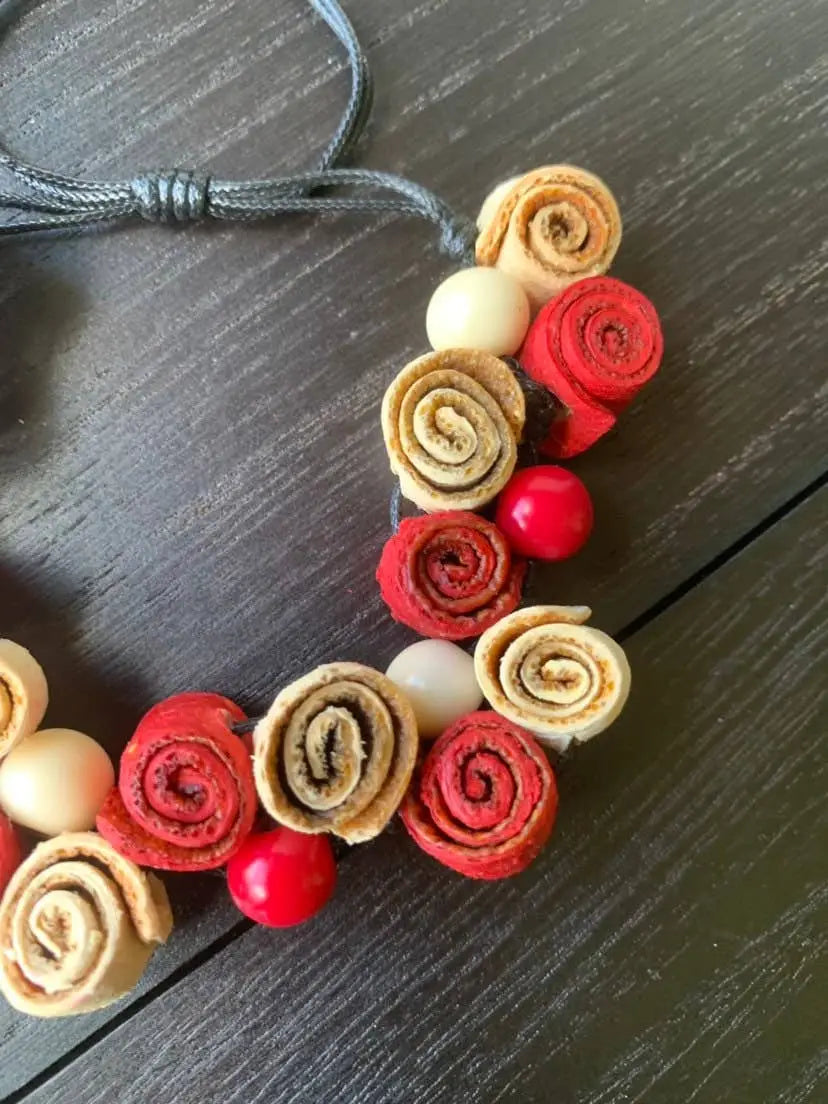 Handmade rose bracelet with red and beige leather roses and beads on an adjustable dark gray cord for fall fashion