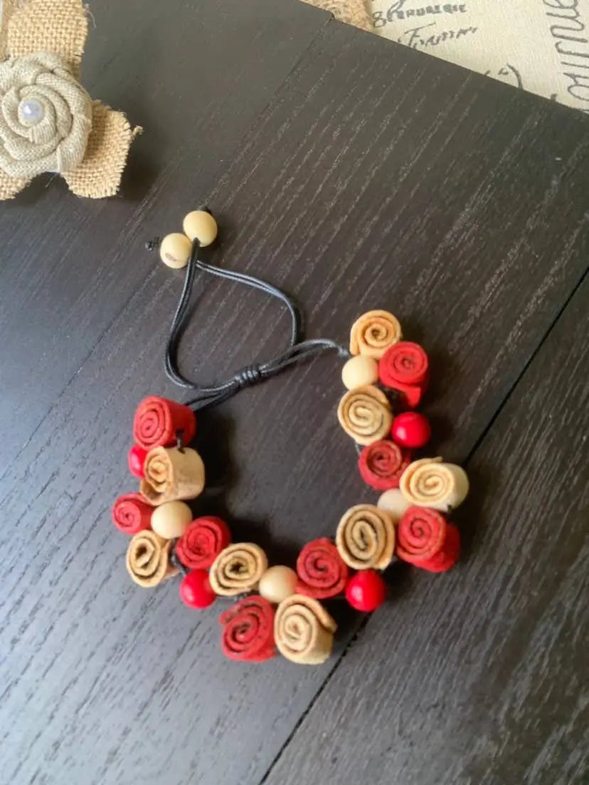 Handmade rose bracelet with red and beige fabric roses wooden beads and black elastic cord perfect for fall fashion 2025