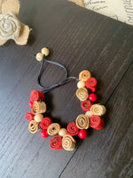 Handmade rose bracelet with red and beige fabric roses wooden beads and black elastic cord perfect for fall fashion 2025