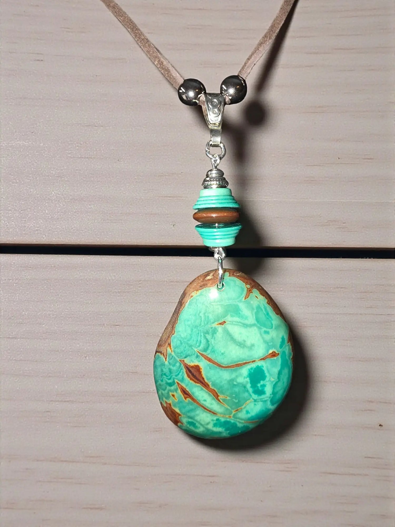 Rustic turquoise colored carved tagua rainforest pendant necklace with turquoise and brown marbled beads and silver clasp
