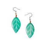 Samira earrings pink teal leaf shaped resin earrings with white veins attached to silver hooks by brown cord