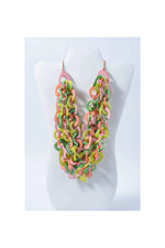 A vibrant three-stranded scarf tagua necklace with pink and lime green interlocking eco plastic links