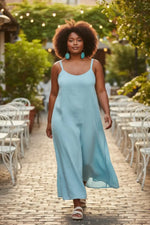 A flowing light blue sleeveless maxi dress paired with sky blue lightweight tagua unique grain earrings center slice