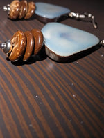 Sky blue and brown agate tagua nut earrings with spiral design and forest seed beads for stylish wear