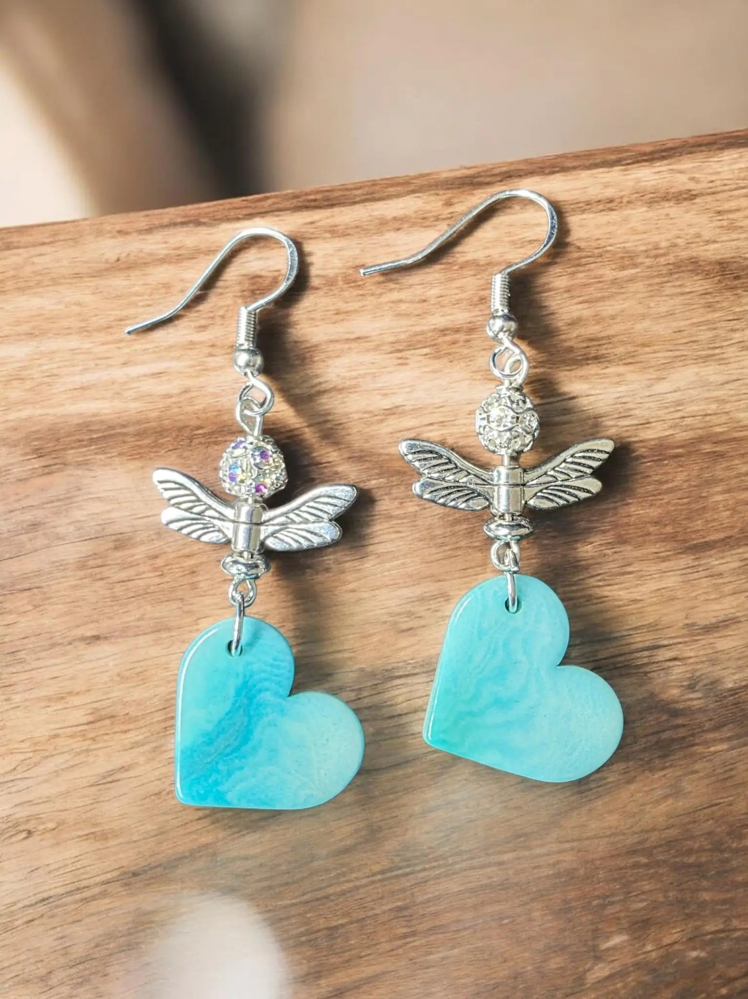 Silver dragonfly earrings with sky blue turquoise heart pendants and crystal accents from rainforest collection