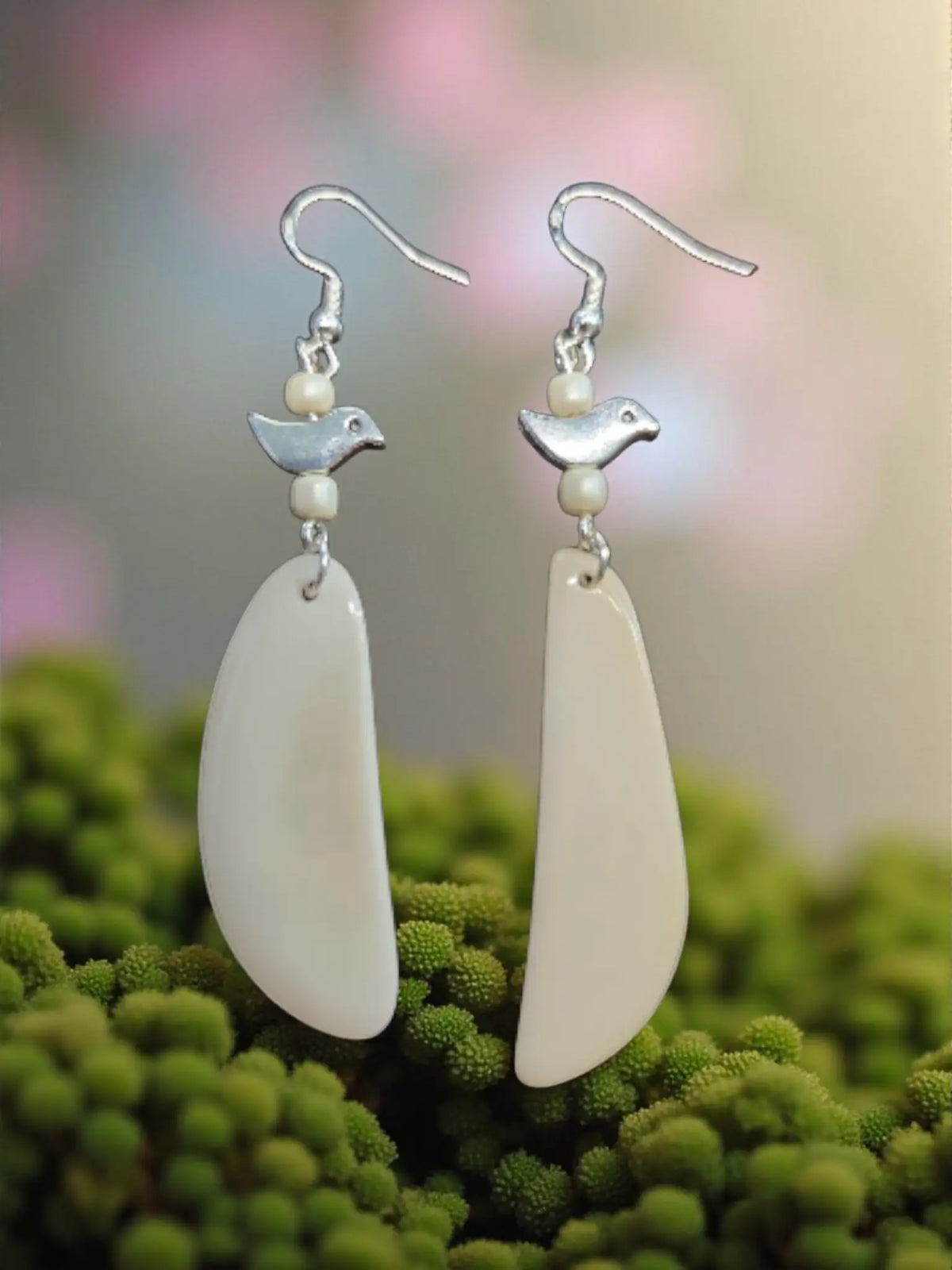 Silver bird-shaped dangle earrings with pearl accents and cream fan tagua lightweight teardrop pendants handcrafted to protect the rainforest