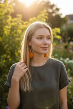 Stunning dreamy orangesickle tagua slice earrings with orange teardrop shape and dangling design