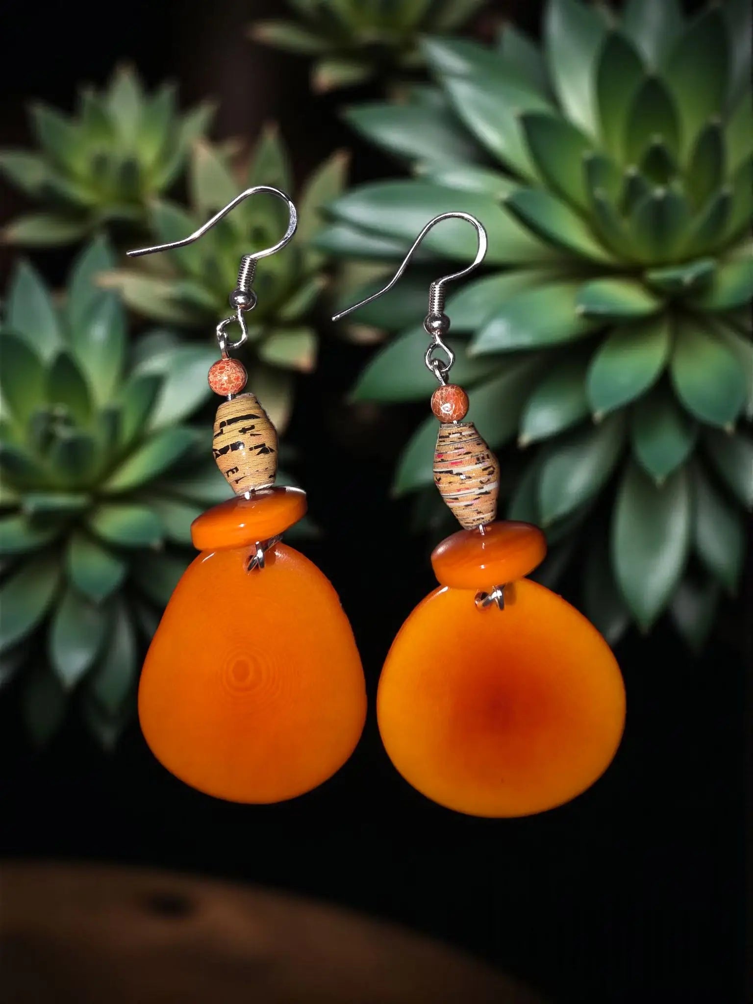 Stunning dreamy orangesickle tagua slice earrings with orange teardrop amber hue and textured cork-like beads above