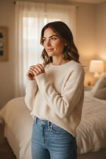 Cream-colored soft-knit long-sleeve sweater with relaxed fit paired with stunning olive green natural unique grain earrings