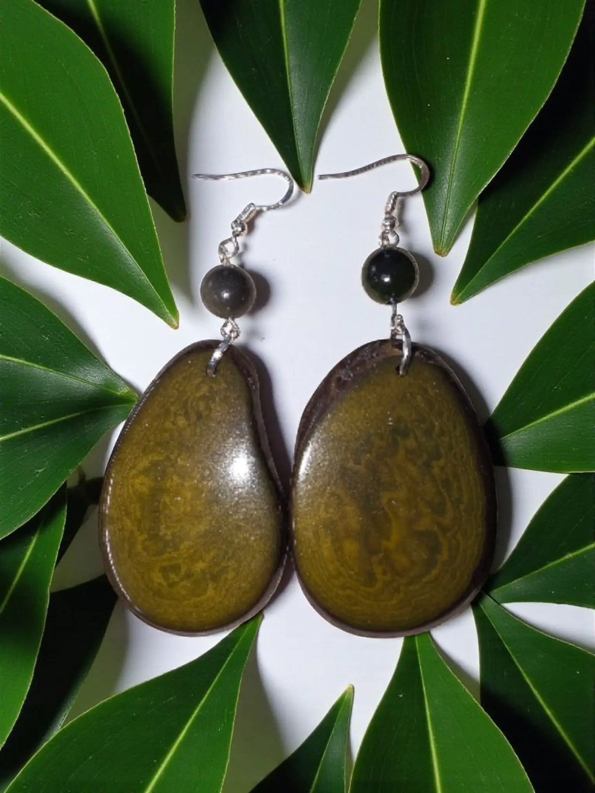 Oval-shaped olive green and brown resin earrings with smooth glossy finish from stunning olive green natural unique grain tagua
