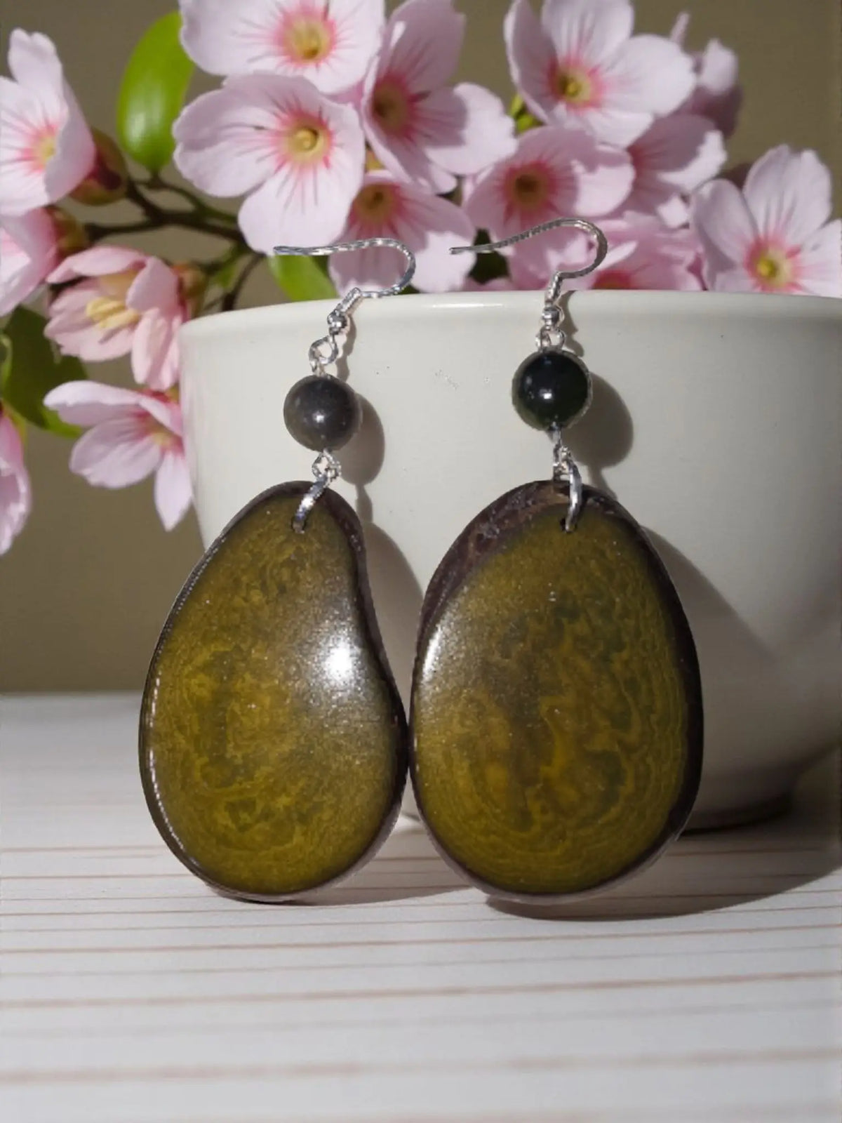 Oval-shaped olive green and brown resin earrings with small black beads in stunning natural unique grain design