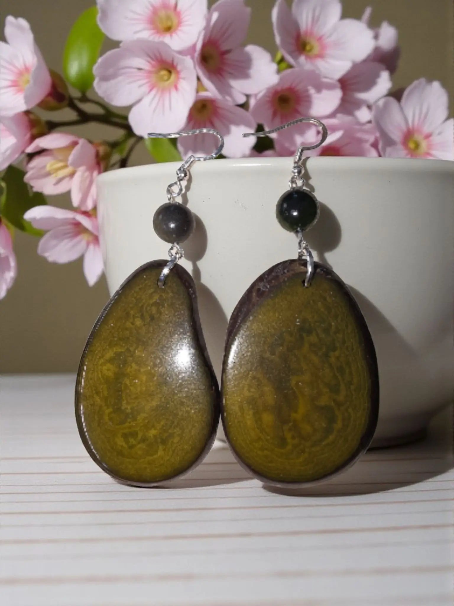 Oval-shaped olive green and brown resin earrings with small black beads in stunning natural unique grain design