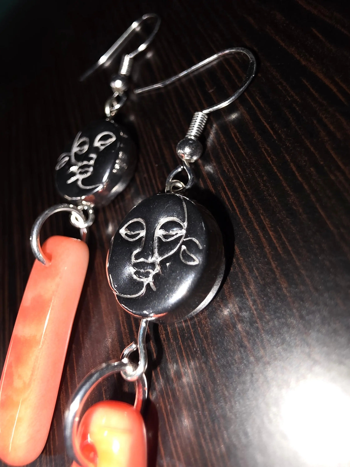 Black oval face pendant earrings with silver hooks and coral peach melon tagua charms sun and moon amulet bead design