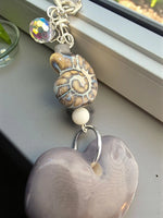 Super thick gray tagua carved heart bag charm with a translucent lavender keychain bead and faceted crystal charm