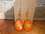 Orange crush tagua slice handmade orange oval wooden earrings with beige star design and three beads on each earring
