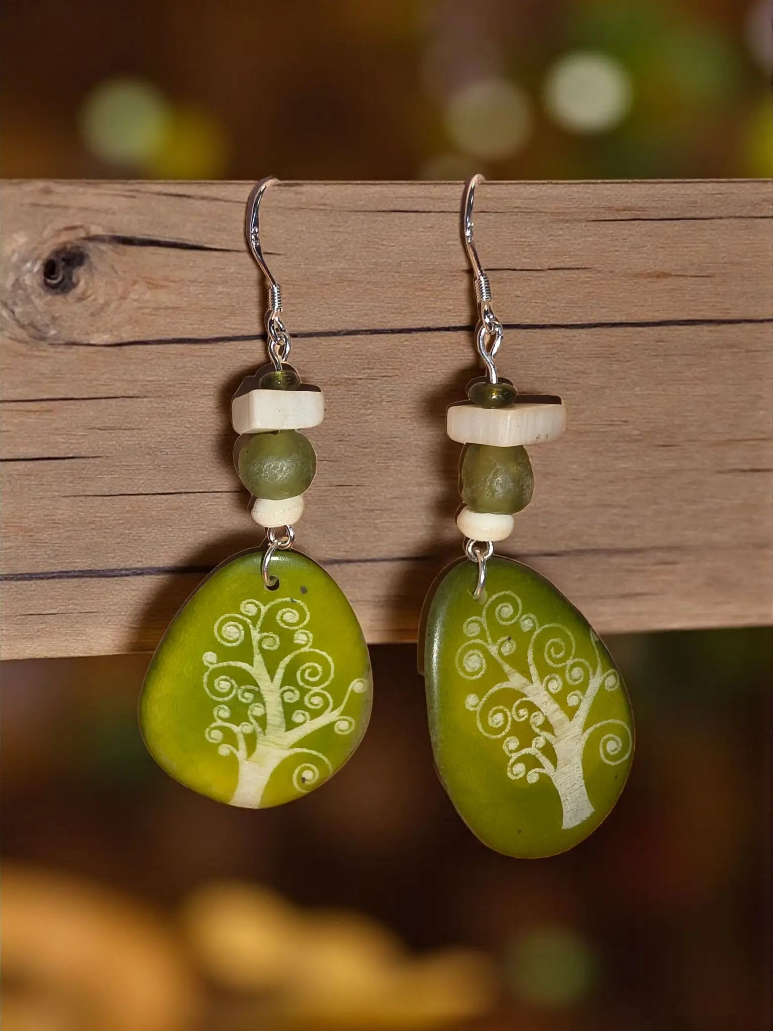 Sweet pea green tree laser engraved tagua slice earrings with white etched designs and silver hooks