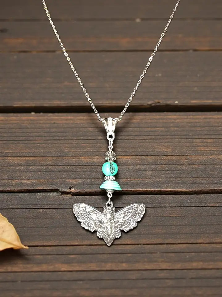Silver cicada moth pendant necklace with turquoise bead accent and lightweight tagua beads charm