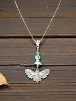 Silver cicada moth pendant necklace with turquoise bead accent and lightweight tagua beads charm