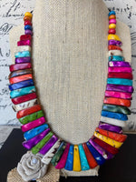 Vibrant multicolored tagua nut necklace with a textured burlap rose pendant handmade and adjustable