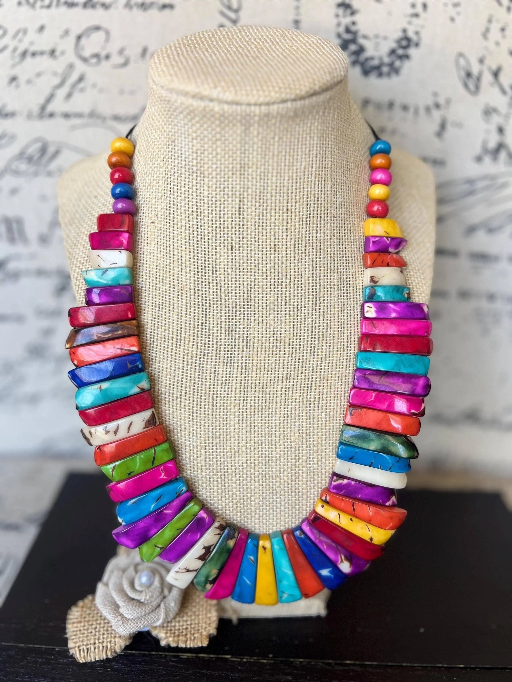 Vibrant multicolored tagua nut necklace with rectangular shell beads and a burlap rose pendant statement nut necklace