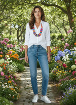 White button-down shirt with rolled sleeves paired with a colorful tagua nut necklace for a bold statement look