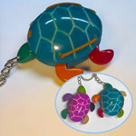 Vibrant turquoise hand-carved tagua animal keychain shaped like a sea turtle with colorful limbs and glossy shell design