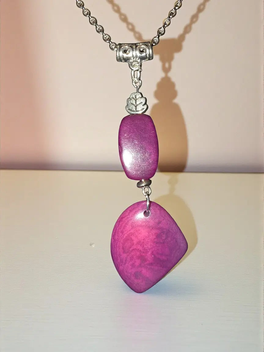 Two plum purple tagua nut pendant necklace with fuchsia vegetable ivory charms and silver leaf accents on chain