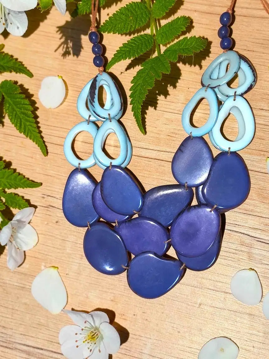 Vibrant vibrant slices of polished tagua nut statement necklace in blue with layered tagua beads and loop accents