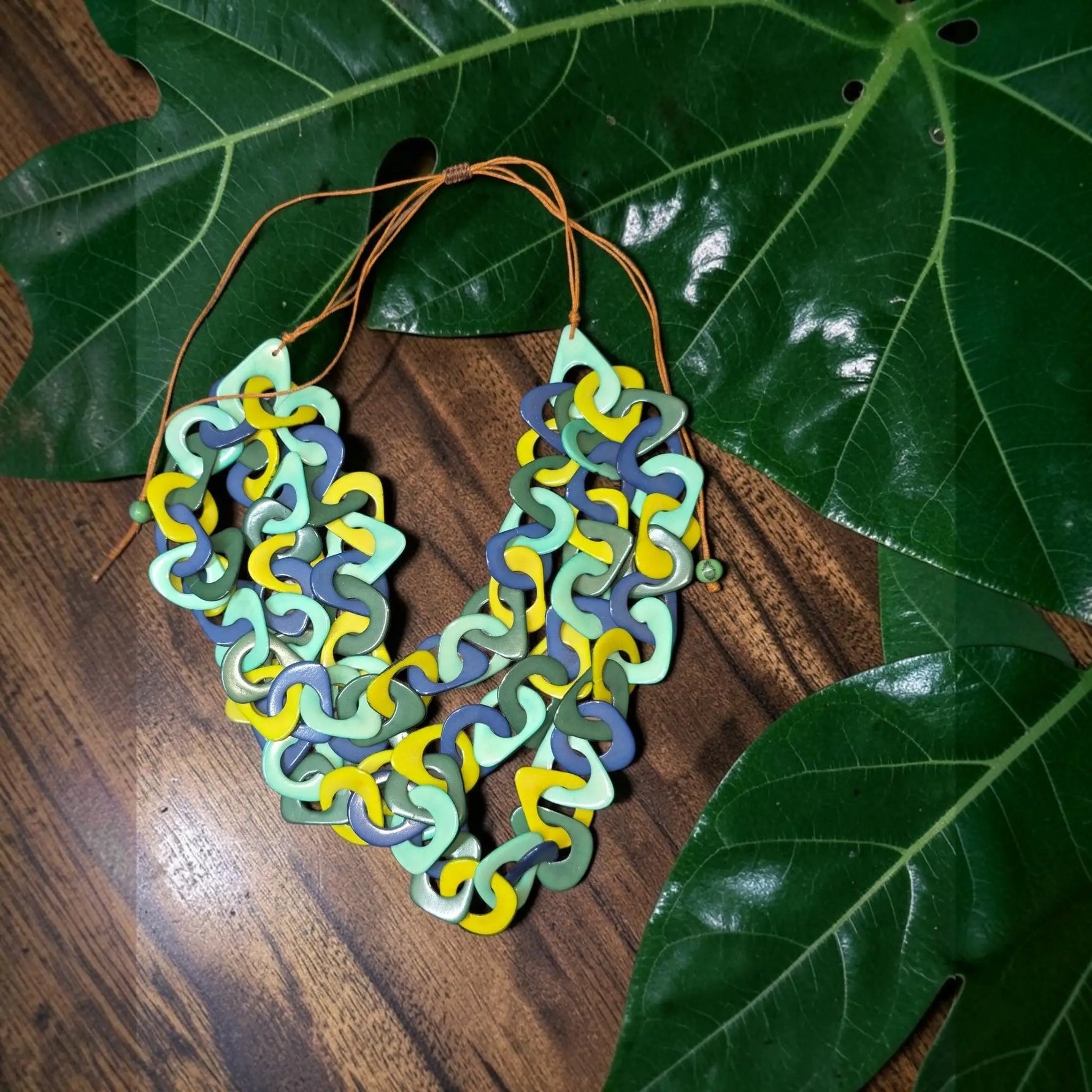 Vibrant three-stranded tagua necklace with interlocking mint green yellow and blue geometric links eco friendly jewelry